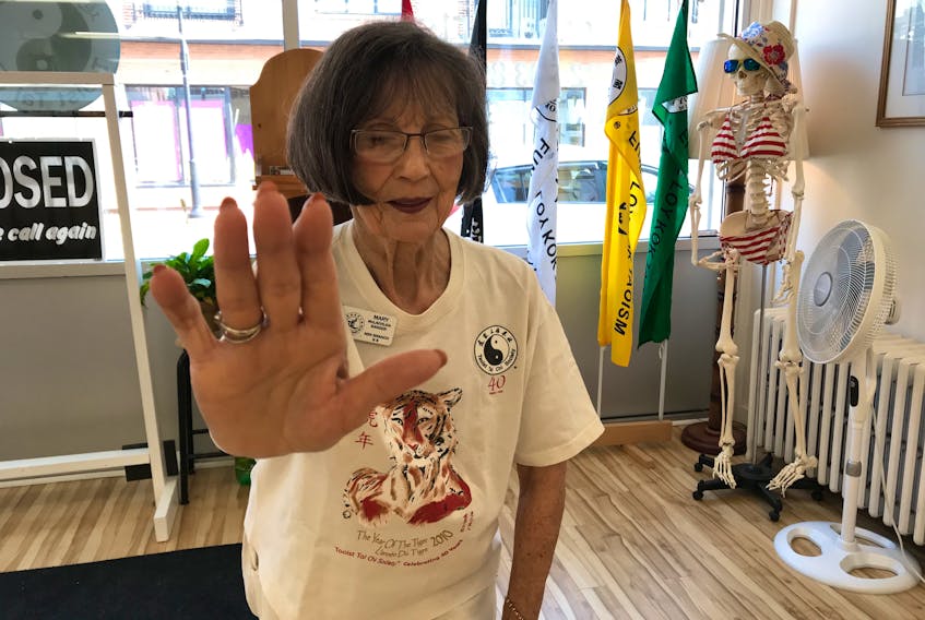 Mary McLachlan-Sanger, seen striking a Tai-Chi stance, had a bacterial infection destroy her right hip bone. A doctor said she would need a walker until her surgery. but she says the healing power of Tai Chi lets her walk using only a stick.