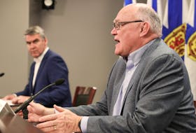 Premier Stephen McNeil looks on as Dr. Robert Strang, the province's chief medical officer of health, gives an update on the latest COVID-19 numbers in Nova Scotia at a news conference in Halifax on Monday, March 30, 2020.
