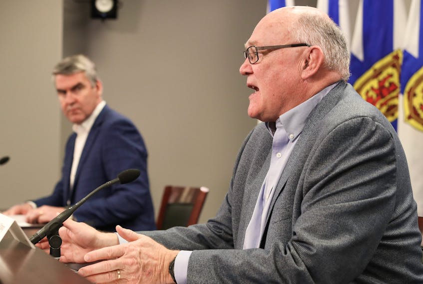 Premier Stephen McNeil looks on as Dr. Robert Strang, the province's chief medical officer of health, gives an update on the latest COVID-19 numbers in Nova Scotia at a news conference in Halifax on Monday, March 30, 2020.