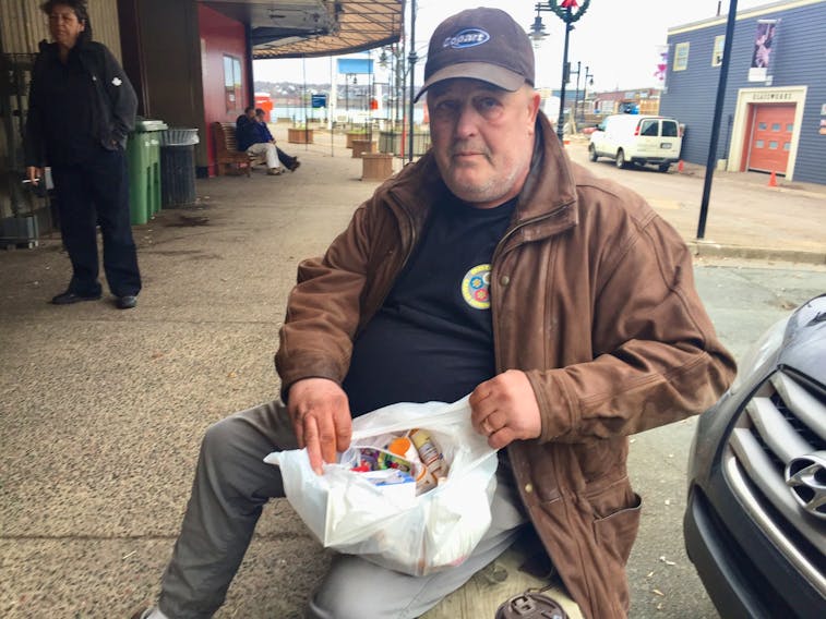 Raymond Marshall shows the many medications he’s taking while living homeless in Halifax.