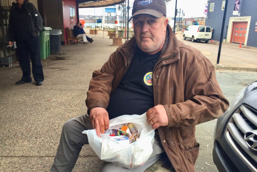 Raymond Marshall shows the many medications he’s taking while living homeless in Halifax.