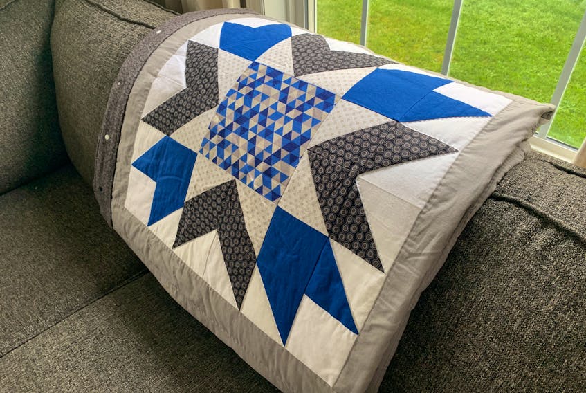 Heather separated her quilt blocks with a three-inch grey border (sashing) around all four sides, then sewed the six blocks together to make a 2x3 quilt top.