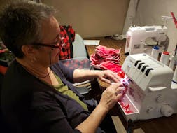 As business slows to a crawl thanks to COVID-19, Maritime Tartan Company's Sherrie Kearney is devoting her time to making facial masks, which will be traded for charitable donations to worthy causes. - Contributed
