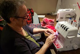 As business slows to a crawl thanks to COVID-19, Maritime Tartan Company's Sherrie Kearney is devoting her time to making facial masks, which will be traded for charitable donations to worthy causes. - Contributed