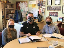 Kevin Veniot, principal of Northeast Kings Education Centre, sits with students Leah Bent and Emily Rutt at the school on March 12, 2021. Veniot said the school has adapted well to the turbulent pandemic year thanks to lots of prepration and co-operation among staff on technological changes.
