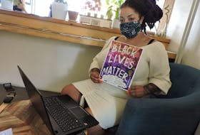 Artist and Taking BLK Gottingen organizer Bria Miller displays the Black Lives Matter poster she designed as a fundraiser for the African Nova Scotian Freedom School, on sale at Alteregos Cafe & Catering. The event promoting Black entrepreneurs in Gottingen Street storefronts continues on Sunday from 11 a.m. to 3 p.m.