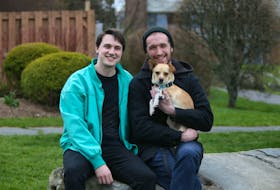 Dylan Timmons, left and  Brody Llewellyn, are seen with their newly adopted dog, Dewey, in Halifax May 15, 2020.