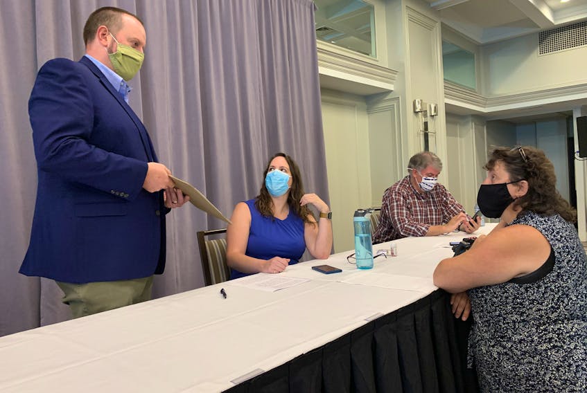 From left to right: Paul Wozney, NSTU president, chats with Nova Scotia Parents for Public Education members Christine Emberley, Adam Davies and Stacey Rudderham at a news conference in Halifax on Thursday, Aug. 27, 2020.
