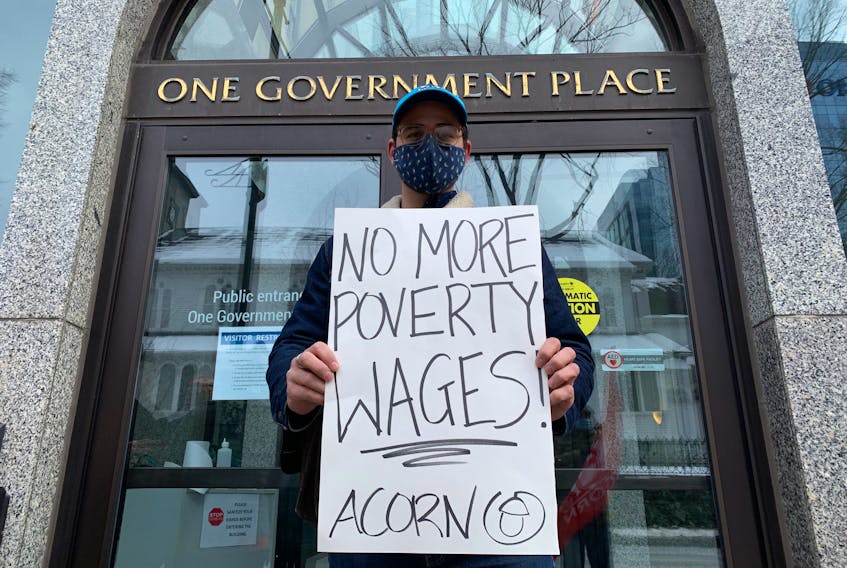 Jacob Wilson stands in front of One Government Place on Barrington Street in Halifax, N.S., on Saturday, Jan. 30, 2021. Wilson was one of a dozen people to rally in front of the government building to call on the soon-to-be new Liberal leader to act on the housing crisis.