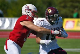 Acadia linebacker Bailey Feltmate tackles Mount Allison's Drew Besco in a recent Atlantic university football game at Wolfville. Peter Oleskevich / ACADIA ATHLETICS