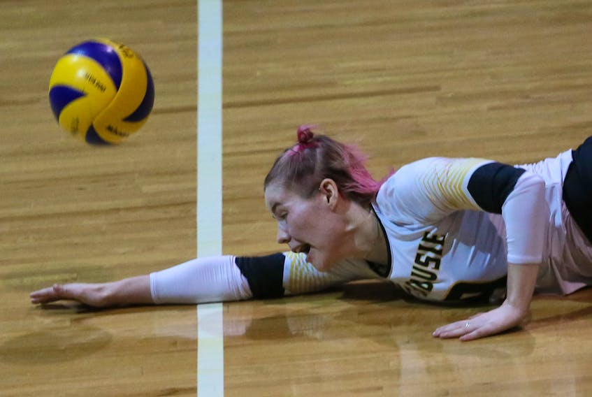 Dalhousie Tigers’ Catherine Callaghan digs the ball during the winning point of the first set against the Saint Mary's Huskies during Game 1 of the AUS women's volleyball championship at Dalplex on Thursday.