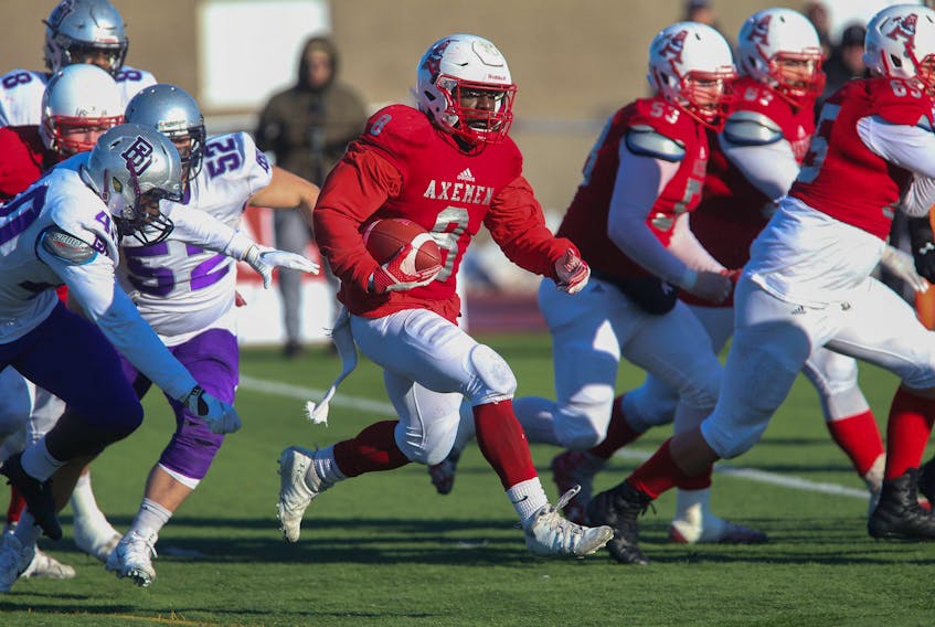 Acadia running back Dale Wright scores one of his three touchdowns against the Bishop's Gaiters during last Saturday's Loney Bowl at Raymond Field. Wright and the Axemen host this weekend's Uteck Bowl national semifinal against the Montreal Carabins. TIM KROCHAK / THE CHRONICLE HERALD