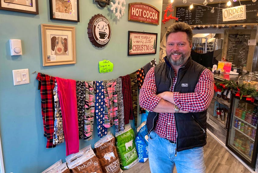 Barking Bean Cafe owner Glenn Deering stands by a display of leggings in his Hantsport business. A labeling mishap this week saw him receive a handgun instead of an expected order of holiday-themed leggings.