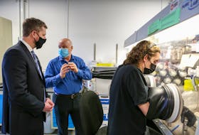 March 29, 2021 - Dr. Jeff Dahn, centre, shows Premier Iain Rankin an experiment a student is working on in an argon atmosphere at the Dalhousie Physics and Atmospheric Science Lab.