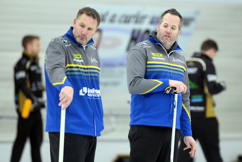 Skip Jamie Murphy, right, and third Paul Flemming discuss strategy at the Deloitte Tankard on Jan. 20 at Dartmouth Curling Club. The Murphy rink opens play at the Tim Hortons Brier on Saturday in Kingston, Ont. ERIC WYNNE / The Chronicle Herald