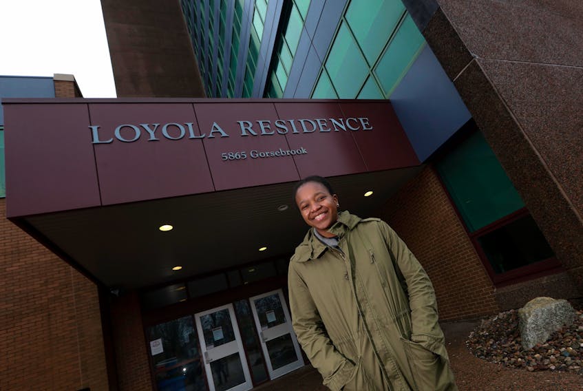 Amanda Katsande smiles in front of the Loyola Residence at Saint Mary's University in Halifax on Thursday, April 2, 2020. Katsande could have headed back to her family in Harare, Zimbabwe, but decided to hang in and “see how things were playing out with classes.”