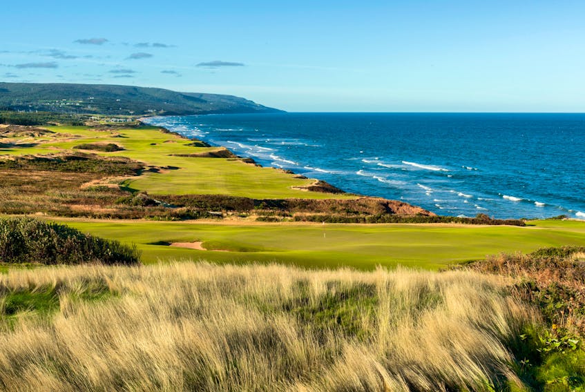 A view over the 12th green with the 18th hole in the background at Cabot Cliffs. 
Evan Schiller Photography