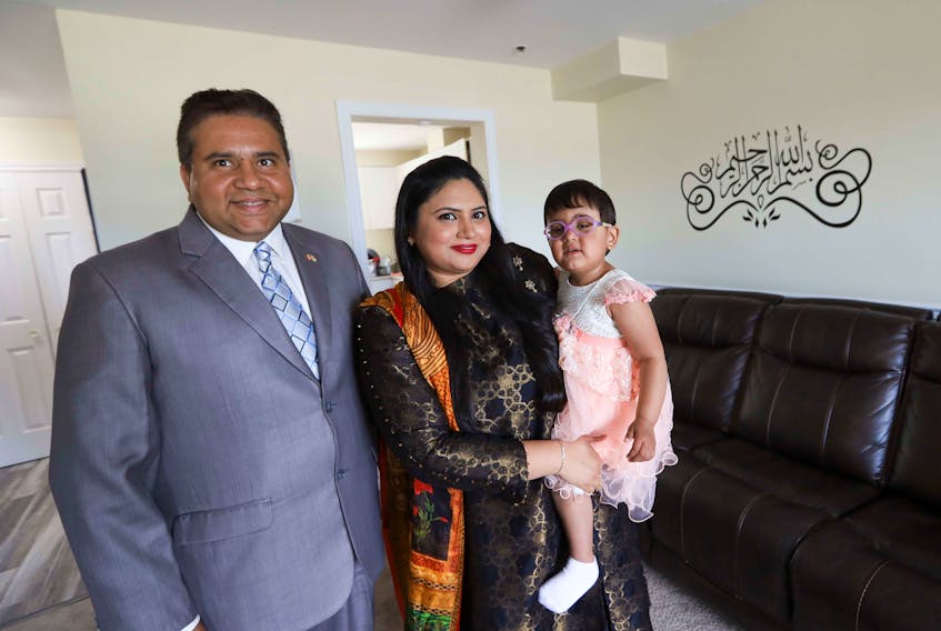 New Canadians Muhammad Ahmad, left, his wife Shumaila Jamil and daughter Aminah Ahman, 2 1/2. The Halifax family took part in a virtual citizenship ceremony.
