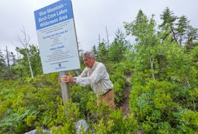 July 20, 2020—James Boyer, co-chair of the environment committee for CARP Nova Scotia, fixes a sign at the trail head for the Blue Mountain-Birch Cove Lakes Wilderness Area in Bayers Lake.  CARP is trying to put their weight behind a movement to retain the wilderness area and is urging the City to contribute the request from the Nova Scotia Nature trust for a $750,000 contribution towards a $2.25 million major land purchase which the Nova Scotia Nature Trust has negotiated for a key connector piece for the park.  Acquiring this large, connector piece of land is critical for the creation of  the future park as per the Municipality’s commitment in its 2014 Regional Plan.