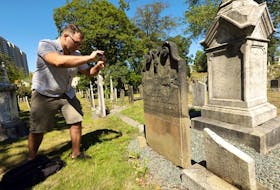 Cemetery explorer Craig Ferguson takes a photo of an ornate gravestone at Holy Cross Cemetery on South and South Park Streets in Halifax for an entry on his @deadinHalifax Twitter account. For the past year, the journalist and TV producer has been sharing stories and sights found in graveyards around the province. - ERIC WYNNE/Chronicle Herald