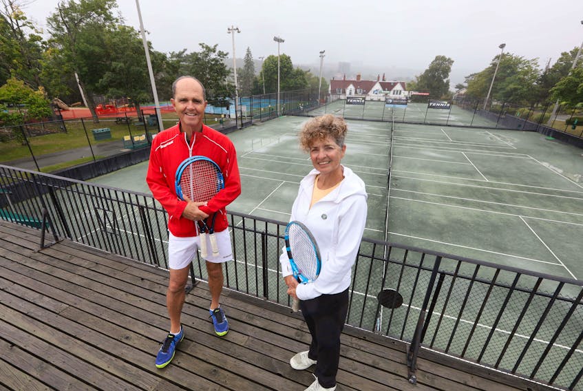 Said Baydar and his tennis mixed-double partner Michelle Karis pose in front of the tennis courts at the Waegwoltic Club on Thursday, Sept. 3, 2020.