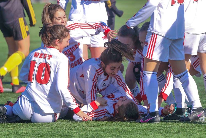 Oct. 31, 2020—Halifax West teammates pile on Lara Freeman after she scored the team’s second goal of the game against the visiting Dartmouth High Spartans at the Halifax Mainland Common Saturday. The goal would be the difference as Halifax went on to take the girls high school soccer championships 2-1.
ERIC WYNNE/Chronicle Herald