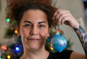Dec. 14, 2020—Eliese MacKinnon holds up one of her favourite Christmas ornaments as she starts to decorate the tree at her mother’s Monday. MacKinnon says COVID has exacerbated her pre-existing mental health conditions.
ERIC WYNNE/Chronicle Herald