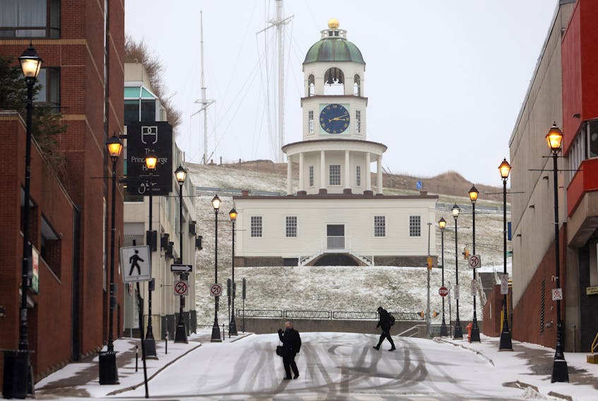 Dec. 17, 2020—Downtown Halifax looked like a ghost town as two pedestrians cross Carmichael Street as a light dusting of snow Thursday afternoon. Overnight and into Friday the snow is expected to get worse with 15-20 cm of snow.
ERIC WYNNE/Chronicle Herald