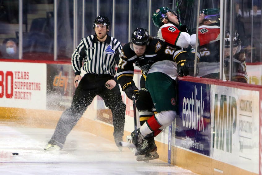 Screaming Eagles' Logan Kelly-Murphy takes Mooseheads' Kyle Petten hard into the glass deep in the Cape Breton end early in the first period during play at the Scotiabank Centre Saturday.
