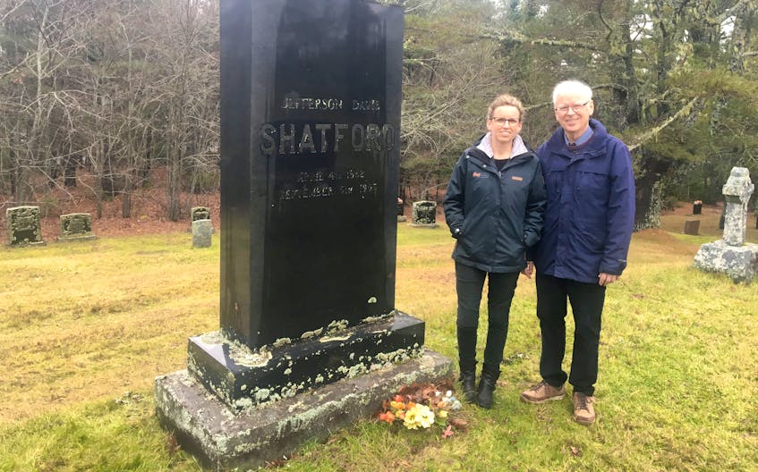 Allyson McKinnon and her father Andy Hare stand beside the Hubbards gravestone of J.D. Shatford.