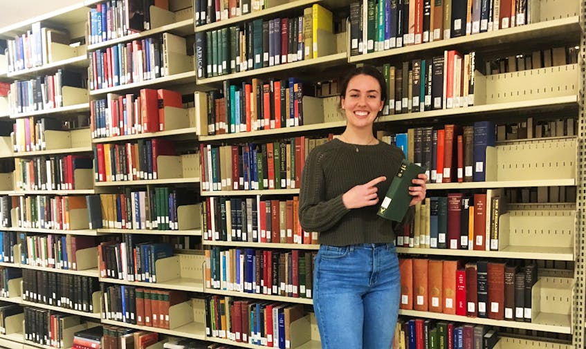 During a photo shoot inside the University of King's College library Rhodes scholar Isabelle Roach found herself standing next to a biography of her benefactor Cecil Rhodes.