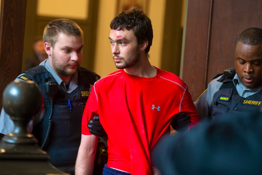 Ryan Richard Lamontagne is escorted into a courtroom at Halifax provincial court on Wednesday, Oct. 23, 2019. Lamontagne, 26, is charged with the second-degree murder of his mother.