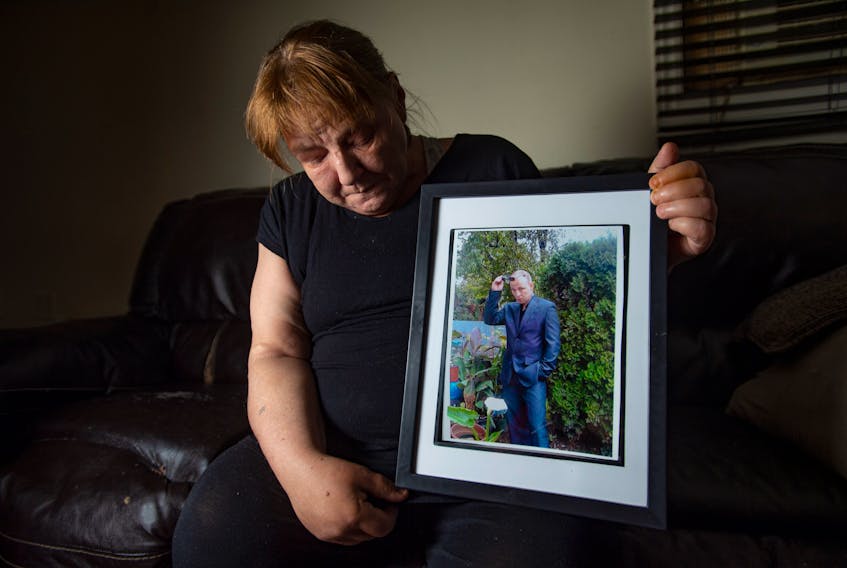 Sheila Hiles holds a photo of her late son Gregory Hiles on Wednesday. Gregory died in August at the East Coast Forensic Hospital in Dartmouth.