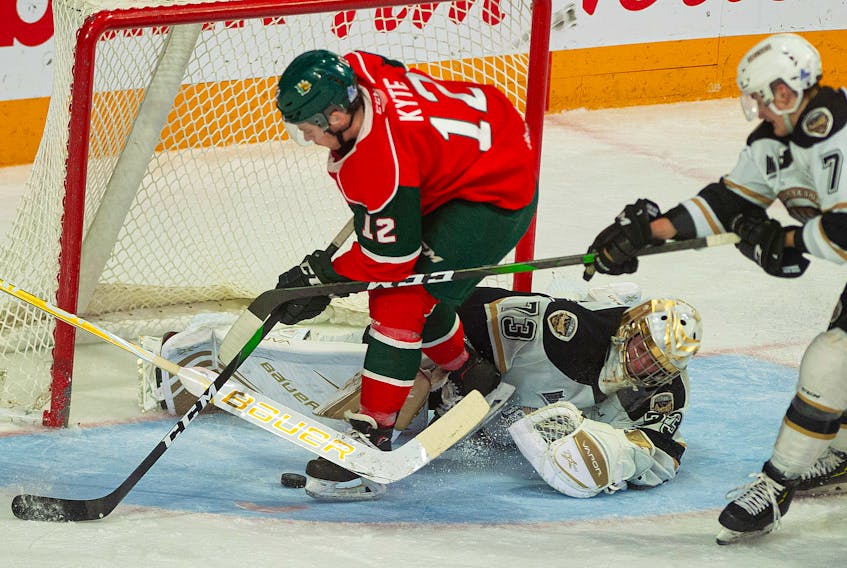 Charlottetown Islanders goalie Matthew Welsh makes a second-period stop on Halifax Mooseheads defenceman Patrick Kyte during Friday night's Quebec Major Junior Hockey League game at the Scotiabank Centre in Halifax.