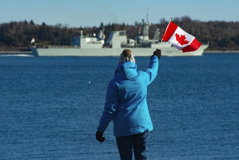 Mary MacAfee waves a Canadian flag as she watches HMCS Halifax leave on a six-month deployment as part of NATO's Operation Reassurance on Friday, January 1, 2021. - Ryan Taplin