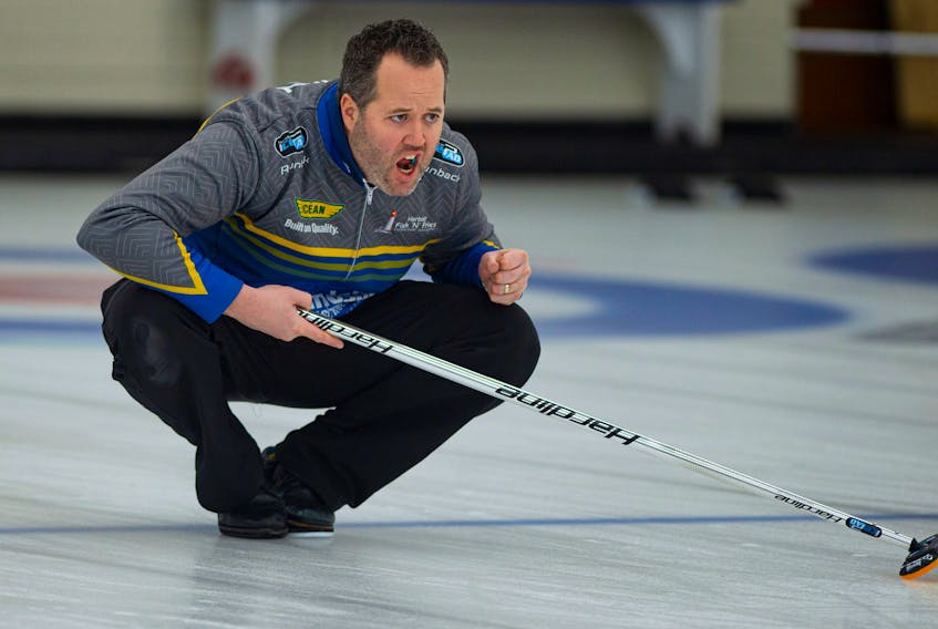 Skip Jamie Murphy throws his rock during the Deloitte Tankard men's curling final against Kendal Thompson  at the Dartmouth Curling Club on Sunday. Ryan Taplin - The Chronicle Herald