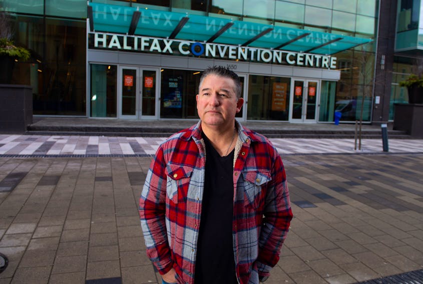 Psychic medium Shawn Leonard poses for a photo in front of the Halifax Convention Centre on Monday, December 27, 2020. Leonard says he tried to book space at the convention centre but they jacked up the price after they found out his occupation.
