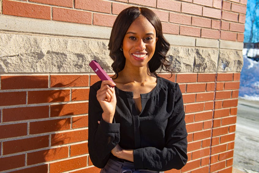Ariel Gough, co-founder and CEO of Bailly Fragrance, holds one of her products for a photo in Bedford on Thursday, Feb. 11, 2021.