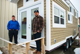 Sophie Eld and Liam O'Rourke with LakeCity Works pose for a photo in front of a tiny home outside the Dartmouth social enterprise on Monday, Feb, 22, 2021. This is the last year for LakeCity's Tiny Home Lottery as they focus on building affordable homes.