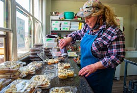Daphne O'Neil drizzles chocolate on some donuts at The Ketobolic Kitchen in Bridgetown on Wednesday, March 24, 2021. O'Neil, and her husband Robert, started the bakery in 2018 after moving from Ontario.