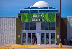 A woman heads into the Halifax Shopping Centre on Thursday. May 21, 2020. While the mall is open, the vast majority of the shops inside remain closed.