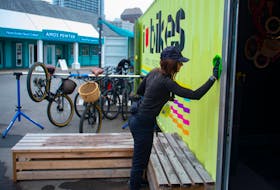 Sarah Craig, owner of I Heart Bikes, cleans the walls at her Halifax shop on Thursday, June 25, 2020. This is the 10th season for the waterfront business.