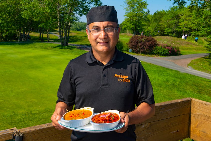 Passage to India owner Sunny Sethi holds a plate with vegetable korma and butter chicken, two items on the menu at his new location at the Granite Springs Golf Club in Bayside.