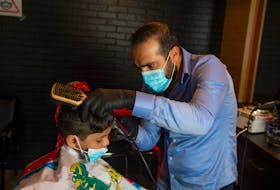 Masoud Alissou cuts four-year-old Hassan Ali's hair in his family-owned barbershop on Thursday, August 20, 2020. Alissou, and his cousin Jakar Al Isso, own two Barran Barber Shop locations - one on Bayers Road and one on Parkland Drive.