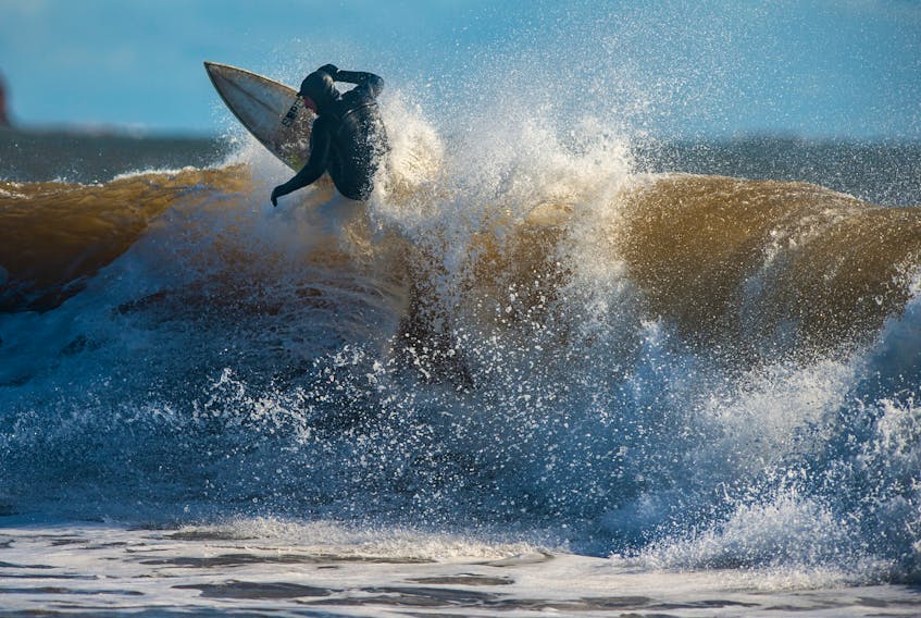 A surfer competes at the Surfing Association of Nova Scotia's Fall Classic short-board contest at Lawrencetown Beach on the weekend. Surfers from Quebec have been accused of travelling to Nova Scotia's beaches and not self-isolating.