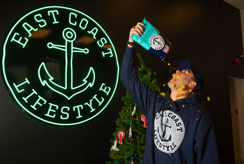 East Coast Lifestyle founder and CEO Alex MacLean knocks back a bag of Covered Bridge East Coast chips on Wednesday, November 18, 2020. East Coast Lifestyle is also coming out with a pineapple rum soda.
