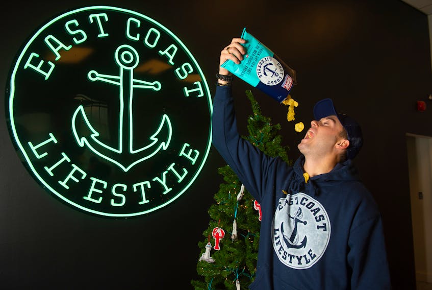 East Coast Lifestyle founder and CEO Alex MacLean knocks back a bag of Covered Bridge East Coast chips on Wednesday, November 18, 2020. East Coast Lifestyle is also coming out with a pineapple rum soda.
