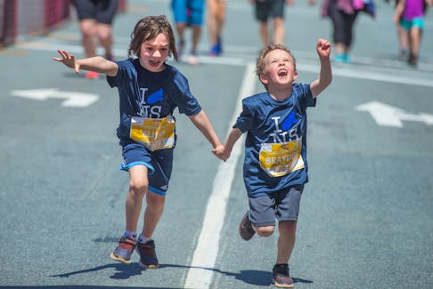 Elijah and Brayden celebrate crossing the finish line in the Doctors Nova Scotia 4 km. run on June 8. Thousands of kids tore through the streets of downtown Halifax in the annual run.