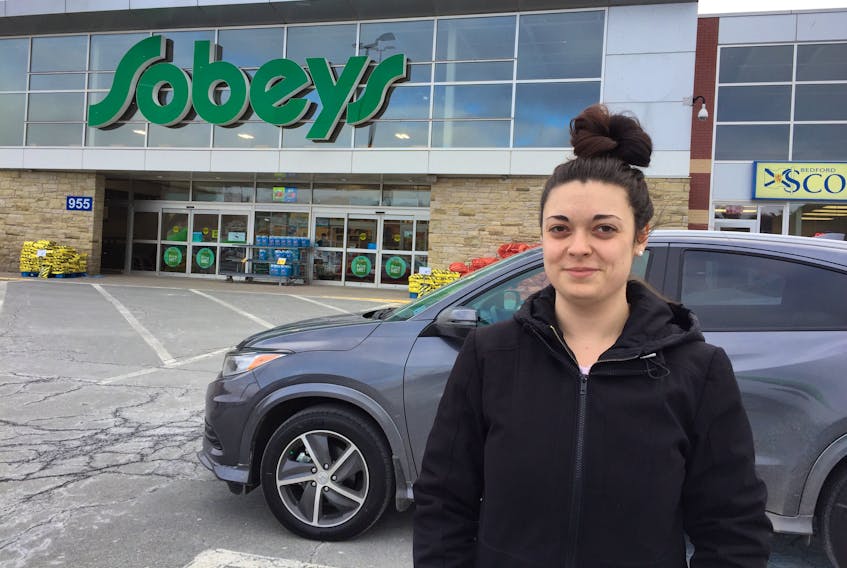 Caleigh Sewards leaves the Bedford-Mill Cove Sobeys store on Thursday morning, Jan. 30, 2020, the final day that the grocery giant has plastic bags available at the checkout.