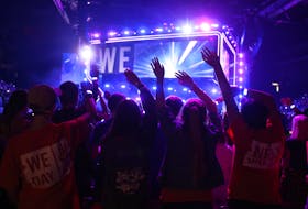 Youths sway their hands during a music performance by pop duo Elijah Woods and Jamie Fine during the WE DAY Atlantic Canada event at the Scotiabank Centre in Halifax Wednesday.